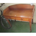 A 19th Century mahogany washstand/desk with gallery on turned legs and two drawers