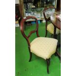 A set of four Victorian balloon back chairs on cabriole legs