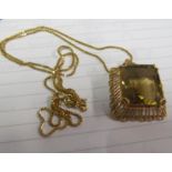 A yellow metal necklace marked 18k & 750 and a gold coloured pendant