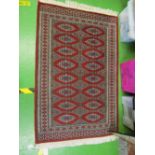 A Bokhara rug, another rug and a mat