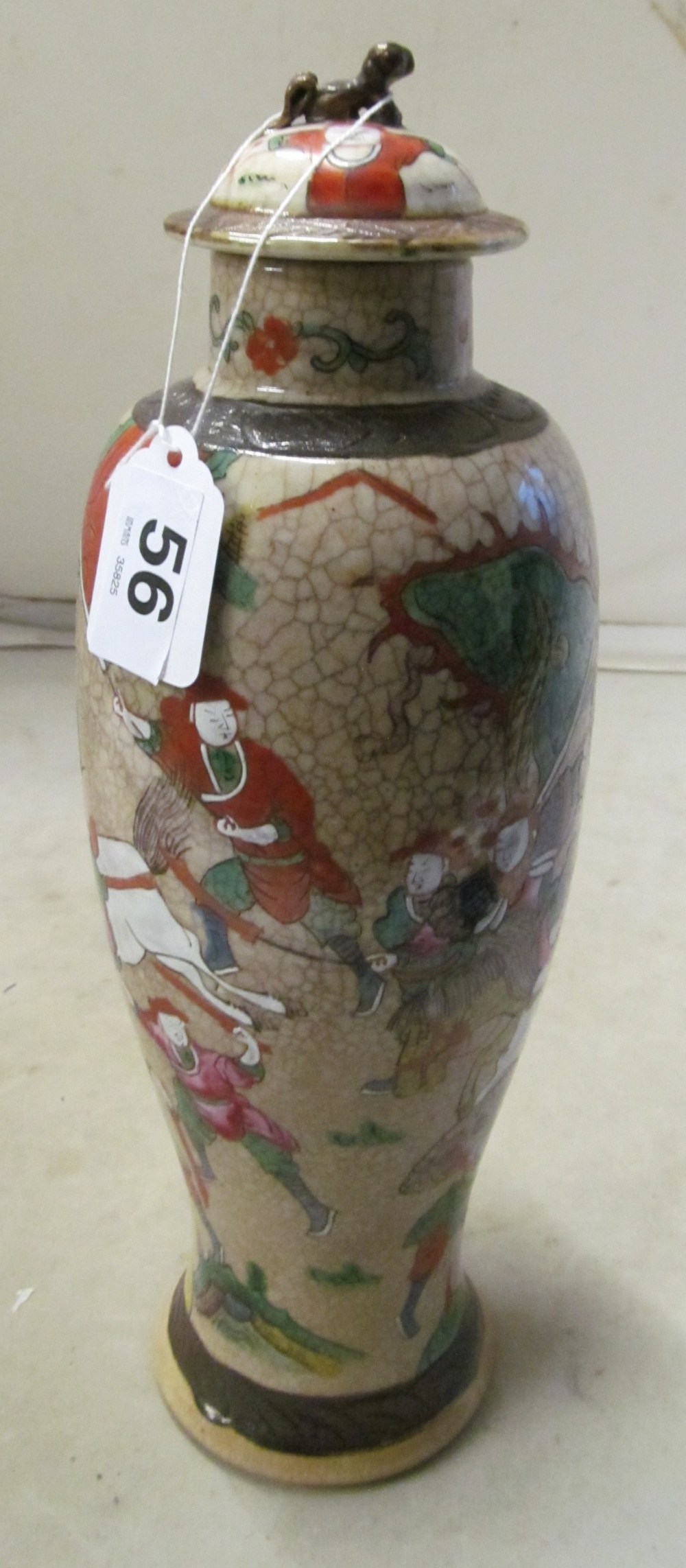 An Oriental lidded baluster vase decorated horses and figures