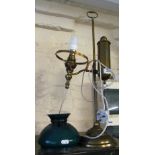 A brass lamp with green shade