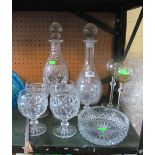 A glass decanter in stand, another decanter, ashtray and some glasses