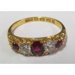A ruby and diamond ring five stones on 18ct gold band, ring size O