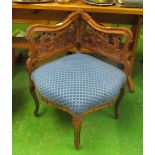 A late 19th Century French corner chair with pierced scroll design back on cabriole legs upholstered