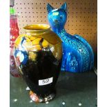 A blue cat and a vase