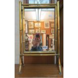 A brass swing mirror and two other small mirrors