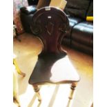 A Victorian mahogany hall chair with arch top