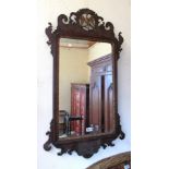 A 19th Century shaped mirror with Hoho bird to top