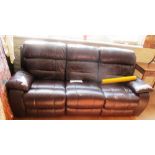 A brown leather three seater settee with electric recliner ends