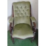 A Victorian button upholstered chair with scroll arms on turned feet