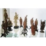 Eight treen oriental figures, two pseudo ivory figures and a Buddha