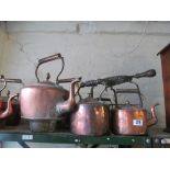 Six copper kettles, smaller one and trivet