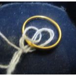 A 22ct gold wedding ring (misshapen) 2.9gm