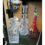 A thistle shaped decanter and two other decanters
