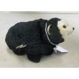 A black toy bear wind up mechanism