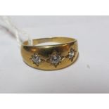 A 9ct gold band set three white stones 3.4gm, size R