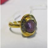 An 18ct purple stone ring 3.3gm, size L/M
