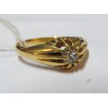 A gold coloured solitaire ring