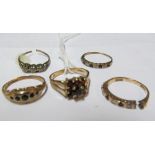 A 9ct gold ring set red stones (one stone deficient) and four other rings