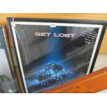 A signed 'Get Lost' poster framed