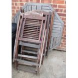 A teak folding garden table and six folding chairs