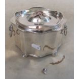 A silver-plated tea caddy on ball feet and lions head ring handles