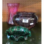 A heavy swirl pattern amethyst glass vase and two other coloured glass items