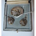 A silver coloured shell brooch inset bird and pair earrings
