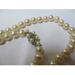 A pearl necklace with 9ct gold clasp of pearls and diamonds