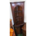 A mahogany corner display cabinet