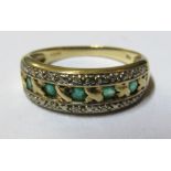 A 9ct gold ring set green stones