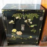A lacquer two door cabinet decorated birds and flowers