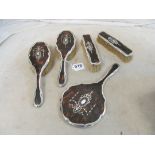 A silver and tortoiseshell dressing table set