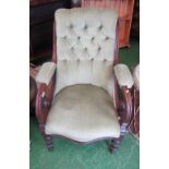 A Victorian button upholstered chair with scroll arms on turned feet