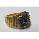 An 18ct gold sapphire cluster ring 11.6gm