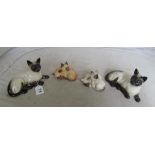 A Beswick Siamese cat, Royal Doulton Siamese cat and two kitten groups Beswick and Royal Doulton