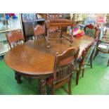 A large oak dining table with two leaves on barleytwist supports and a set of six oak dining