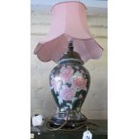 A modern floral pink and green pottery table lamp and shade