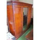 A Victorian mahogany mirror door wardrobe one side fitted with trays, two short and two long