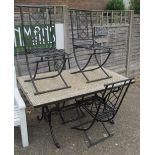 A tile top and wrought iron garden table and four chairs