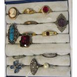 A cameo ring and a group of other rings in ring box