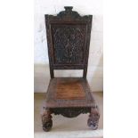 An Indian low chair carved with figures and flowers on elephant supports