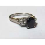 A gold coloured sapphire and diamond ring marked 18k
