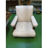 A Victorian armchair upholstered in cream and matching ottoman box