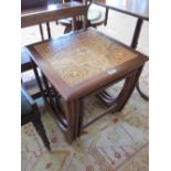 A nest of 1970s teak tables the largest with tile top