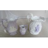 Three Wedgwood style mauve and white relief jugs