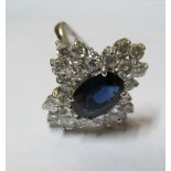A gold coloured sapphire and diamond cluster ring marked 14k 1.78 on shank