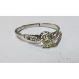 A platinum single stone diamond ring (draws yellow) (0.25-0.5ct spread)
