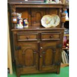 A small oak 1920s oak court cupboard with carved 'S' scroll design, arched panelled doors and carved